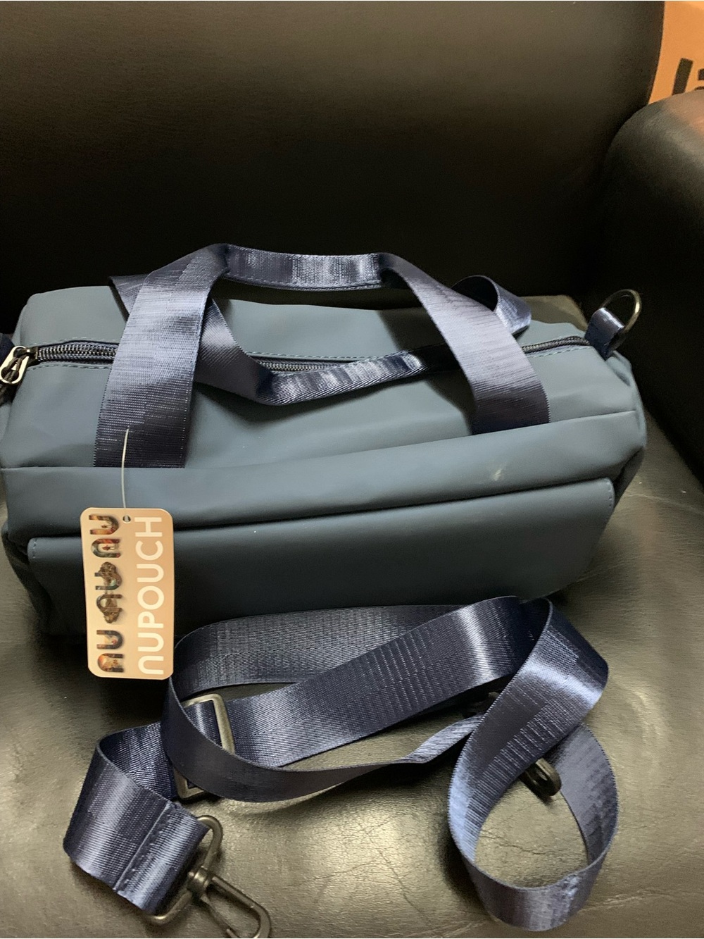 Navy Nupouch daily duffle bag. Pocket on front